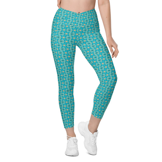 Front view of high-waisted leggings featuring a striking turquoise geometric pattern and handy side pockets. Suitable for running, yoga, or casual pickleball outings