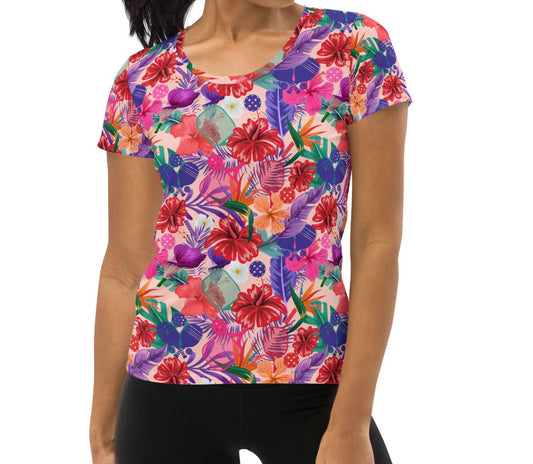 Full front view of a woman modeling the Tropical Oasis Pickleball Performance Shirt. The shirt features a dynamic, colorful floral design, suitable for sports and casual wear, available at OOKAMI SPORTS.