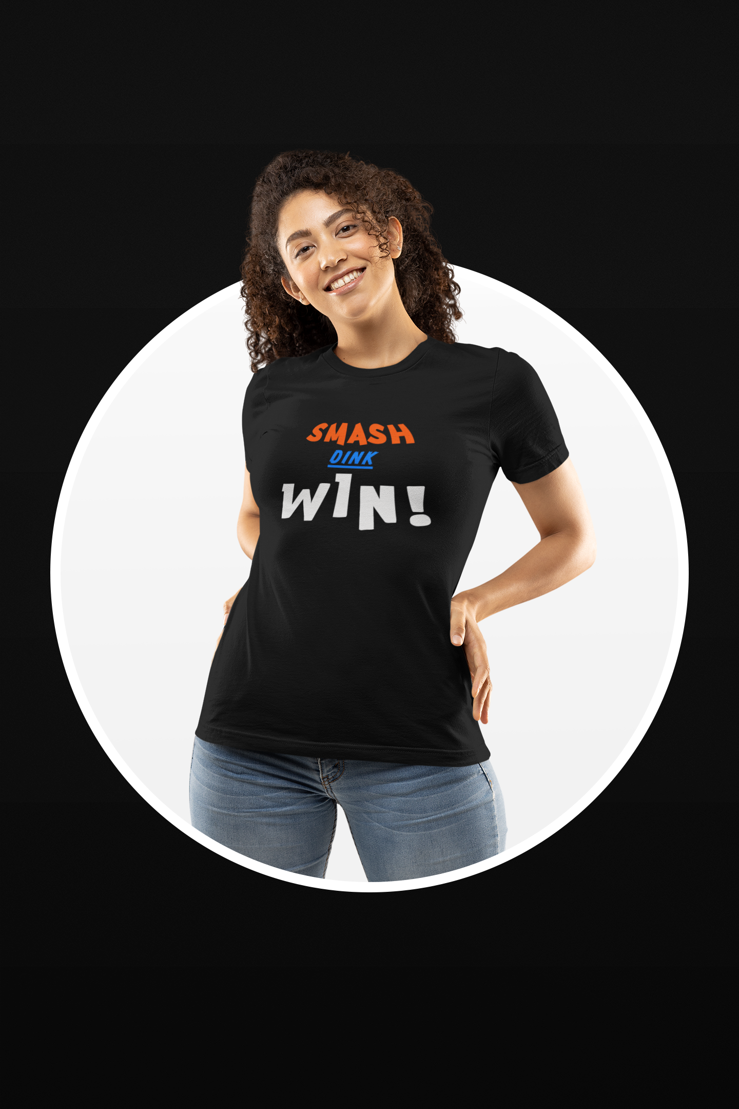 Smiling woman wearing a black t-shirt with the text "SMASH DINK WIN!" in bold, colorful letters, posing confidently against a stylish gradient background. The design highlights an energetic and positive pickleball message.