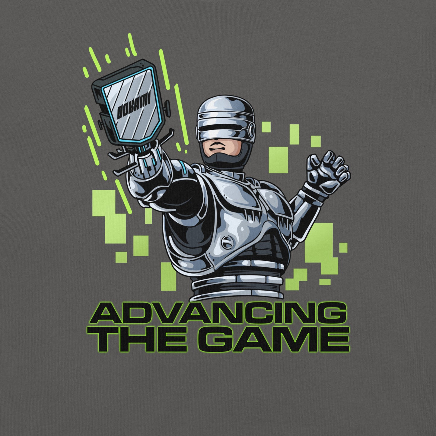 Close-up of the Robocop-inspired graphic design on a gray pickleball T-shirt, featuring neon green pixel accents and the phrase 'Advancing the Game' from OOKAMI SPORTS.